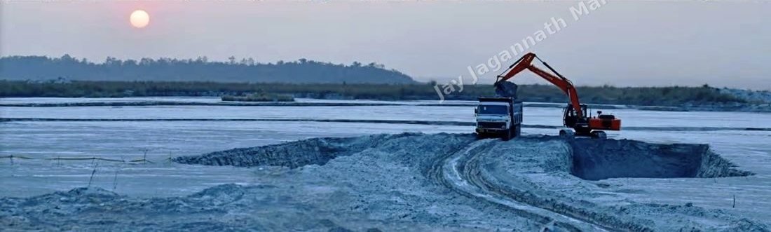 Excavator loading pond ash into a tipper at the ash pond